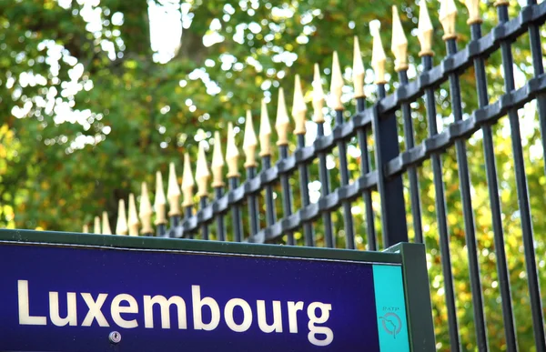 Luxembourg bus stop sign with the Luxembourg Garden grille in the background. Paris, France — стокове фото