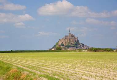 Cultivated fields and Mont Saint-Michel clipart