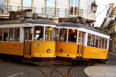 Old fashioned yellow trams in Lisbon clipart