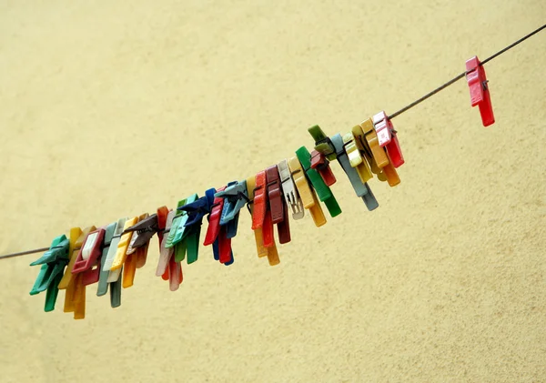 Row of old colored clothes pins — Stock Photo, Image
