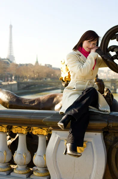 Beautiful girl in Paris sitting on the balustrad — Stock Photo, Image