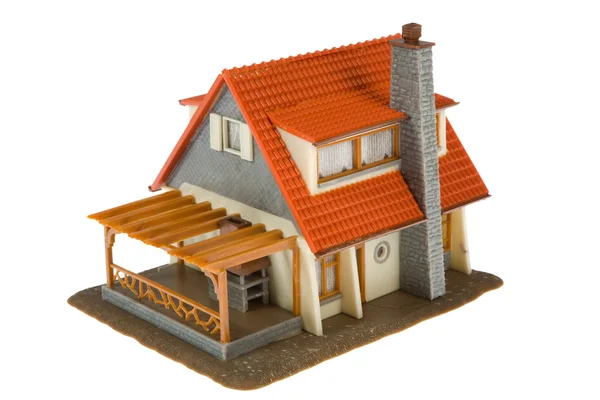 Casa em miniatura com dólares isolados — Fotografia de Stock