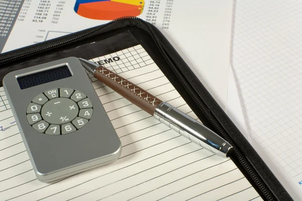 Calculator and pen on a white — Stock Photo, Image