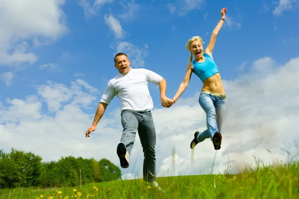 Young family jumping — Stock Photo, Image