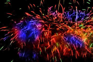 Colorful fireworks over a night sky clipart