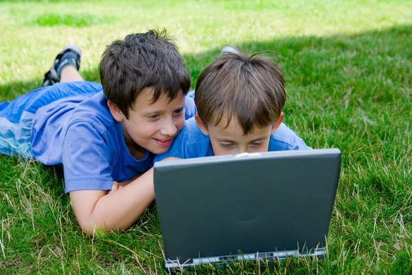 stock image Three cute brothers study on computer