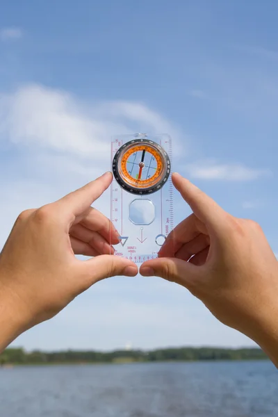 stock image Hand with compass on background sky