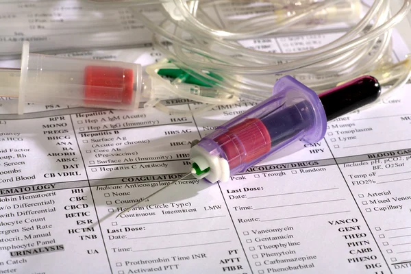 Close up of syringe with test tube — Stock Photo, Image