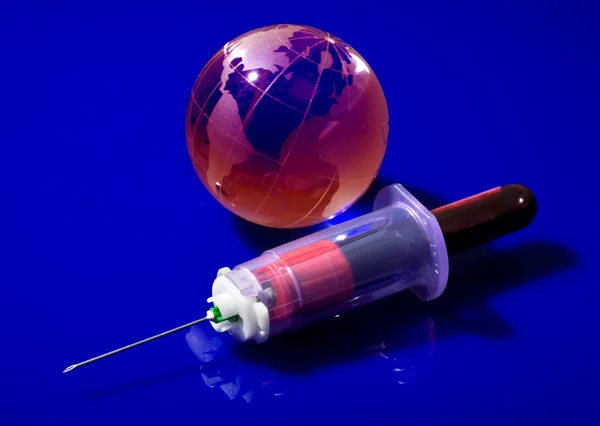 Stock image Glass globe with a syringe