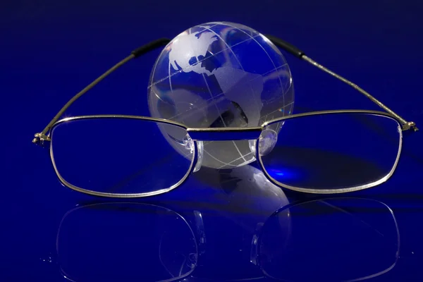 Glass globe with a glasses — Stock Photo, Image