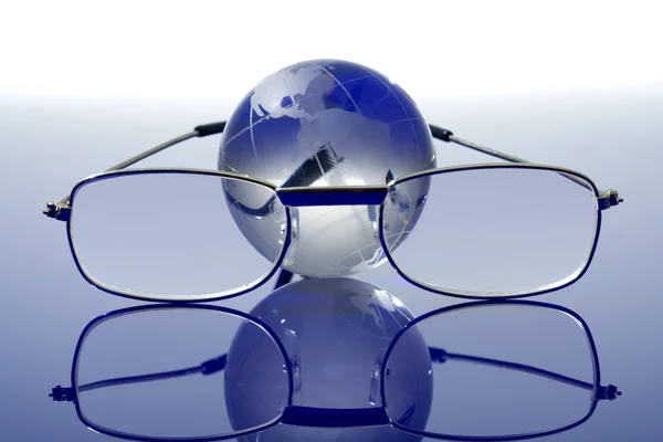 Glass globe with a glasses — Stock Photo, Image
