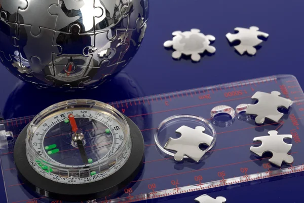 Globe puzzle with compass — Stock Photo, Image