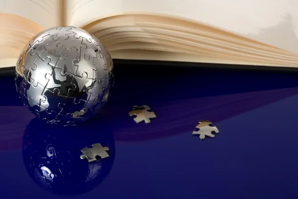 Globe puzzle with book — Stock Photo, Image