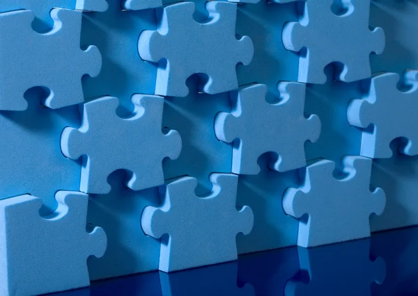 3D blue puzzle on blue background. — Stock Photo, Image
