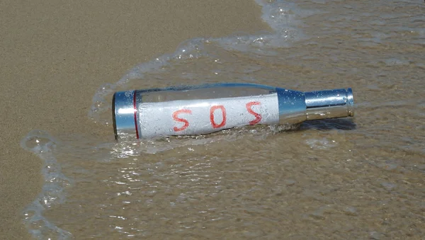 Message in a bottle with SOS signal — Stock Photo, Image