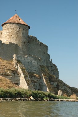 Old fortress on the river bank clipart