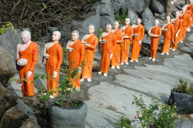 Statues of buddhist monks at Dambulla clipart