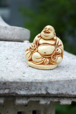 ANTIQUE IVORY BUDDHA STATUE clipart