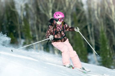 Girl riding on skis clipart