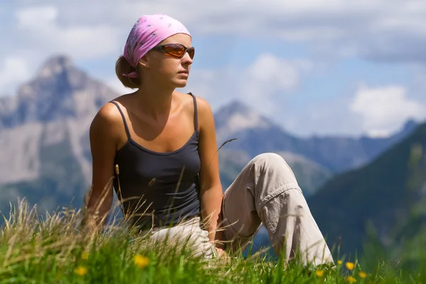 stock image Young woman sitting on a hill