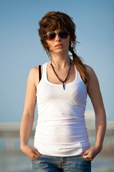 stock image Young girl walking on a beach