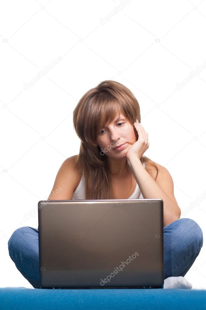 Young girl thinking with laptop