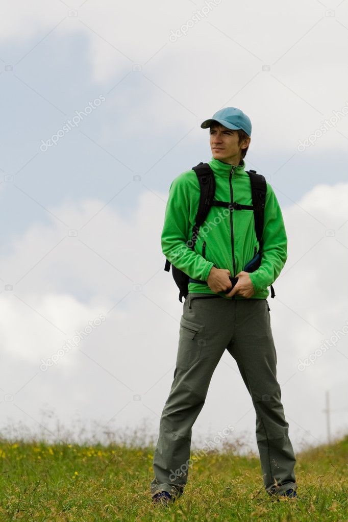 Young man on top of mountain