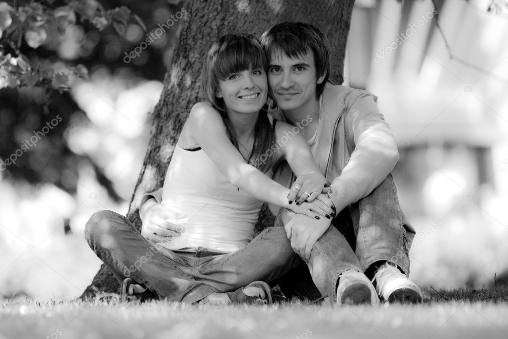 Happy young couple in park. B/W photo