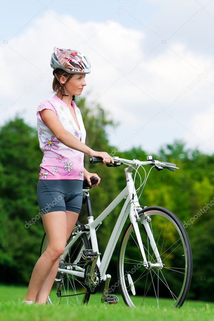 Girl standing with a bicycle
