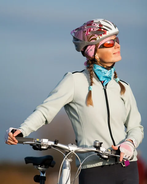Aktive junge Frau mit ihrem Fahrrad — Stockfoto