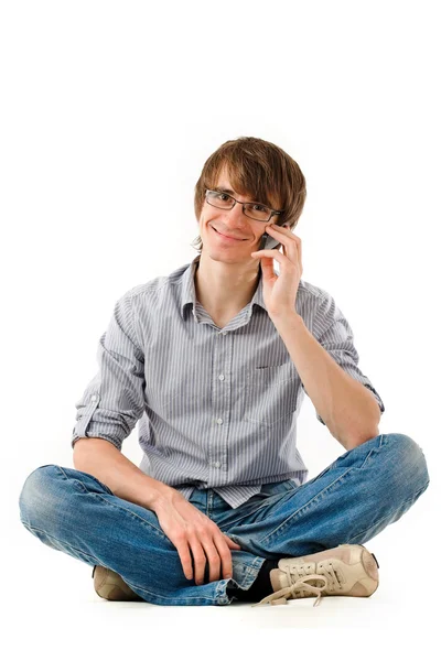 Красивый молодой человек с мобильным телефоном — стоковое фото