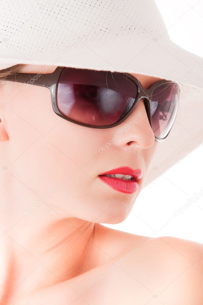 Elegant woman with sun glasses and white