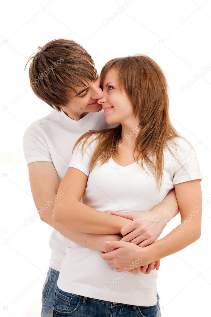 Young happy couple cuddling with smiles