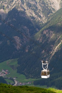 Cable car high in the mountains clipart