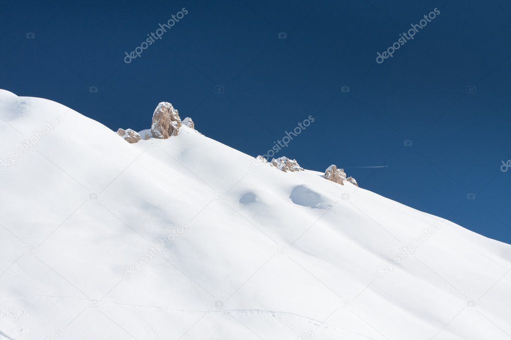 Snow covered hill and sky