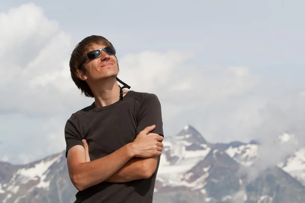 stock image Young man high in the mountains