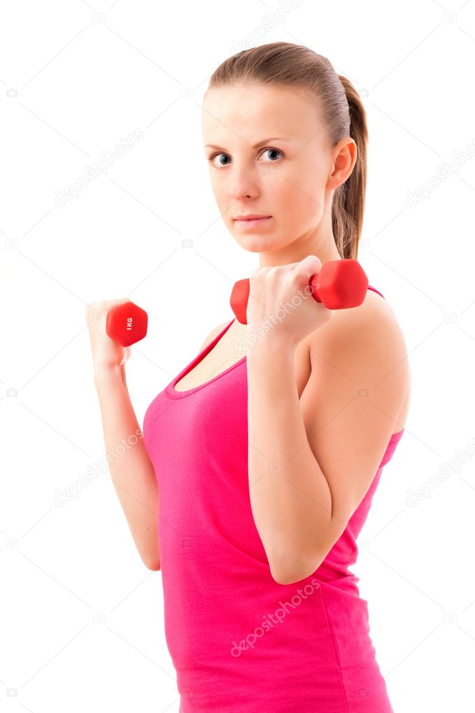 Young fit woman lifting dumbbells