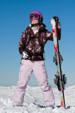 Girl skier with skis clipart