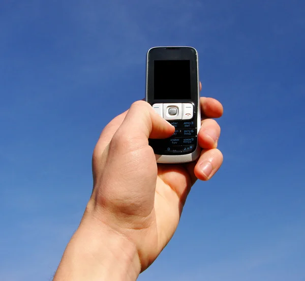 手での携帯電話ένα κινητό τηλέφωνο — Φωτογραφία Αρχείου