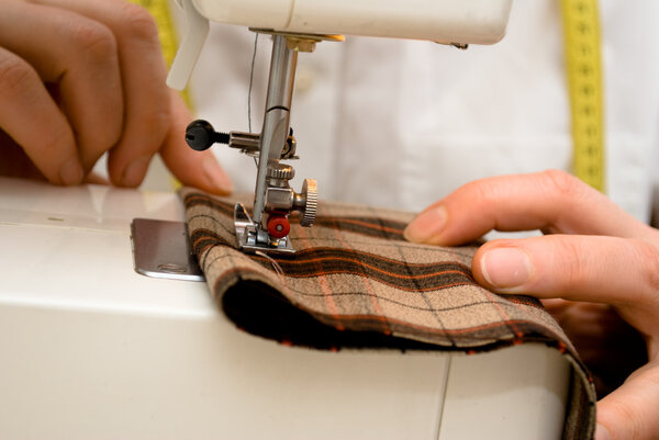 Sewing, white sewing machine with brown clothing