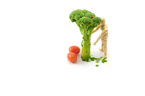 Houten man onder broccoli boom — Stockfoto