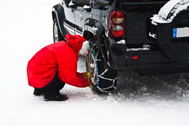 Man installing tire chains clipart