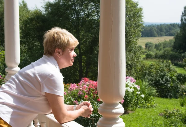 Woman on the porch of a country house — Stock Photo, Image
