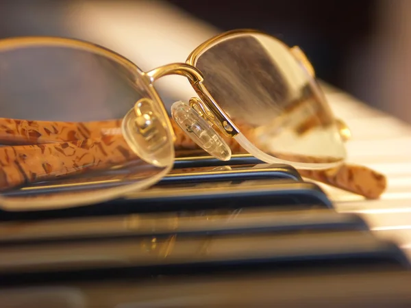 stock image Glasses on the piano keys