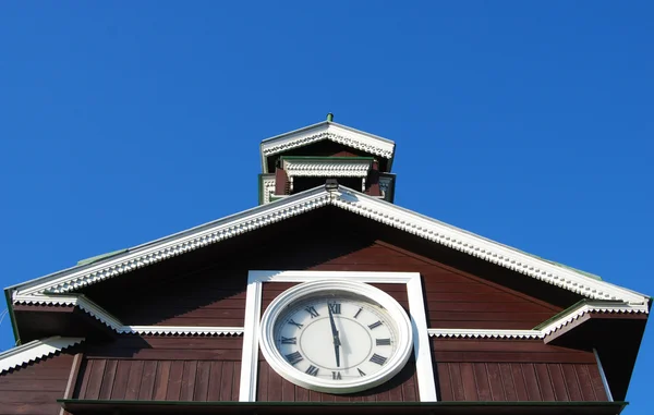 Часы на старом деревянном строении — стоковое фото