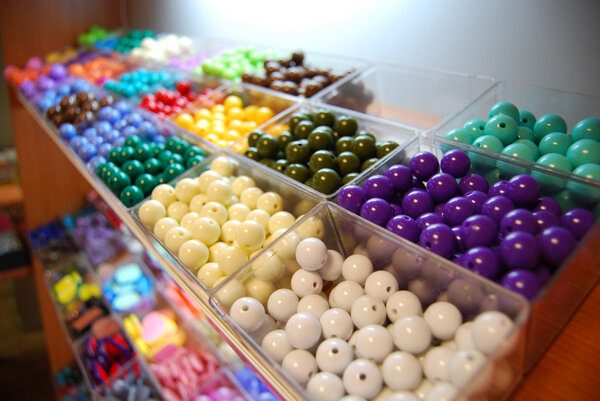 Multicoloured beads in boxes for sale