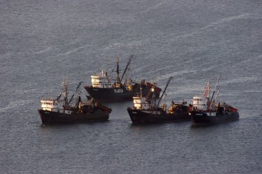 Group of trawlers in the ocean clipart