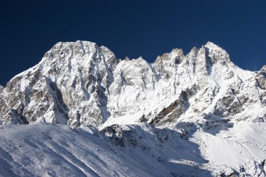 Blue sky over mountains after snowfall, Himalayas, Nepal clipart