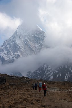 Trekkers going down from Cho La pass in Himalayas, Nepal clipart