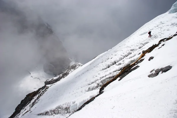 Bergsteiger überquert Berghang in großer Höhe, Himalaya, Nepal — Stockfoto
